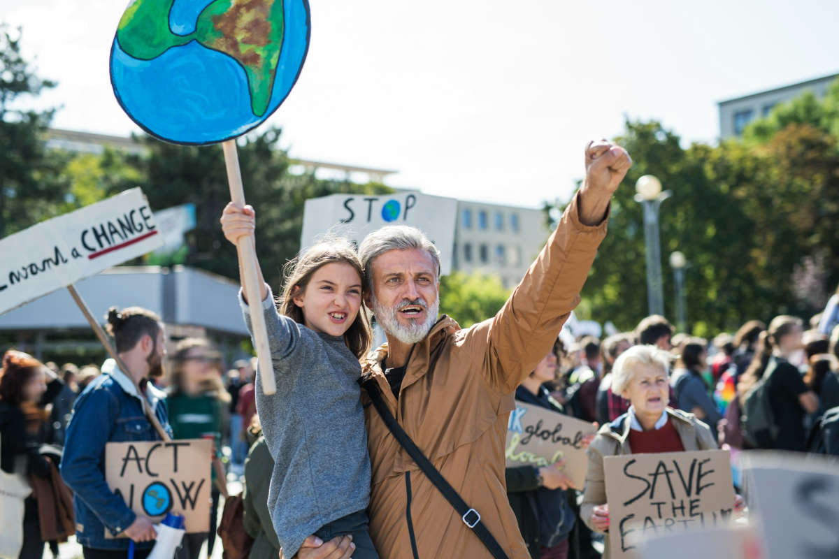 people with placards and posters on a global strike for climate change